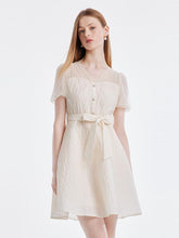 A lady wears a white dress to the casino.